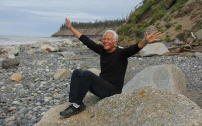 baby boomer on rocks at beach