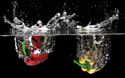 red and yellow pepper splashing into water