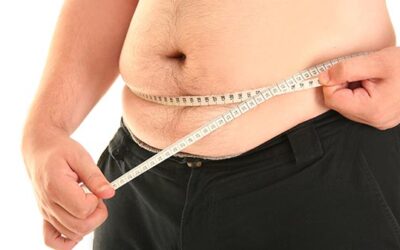 man with tape measure around belly
